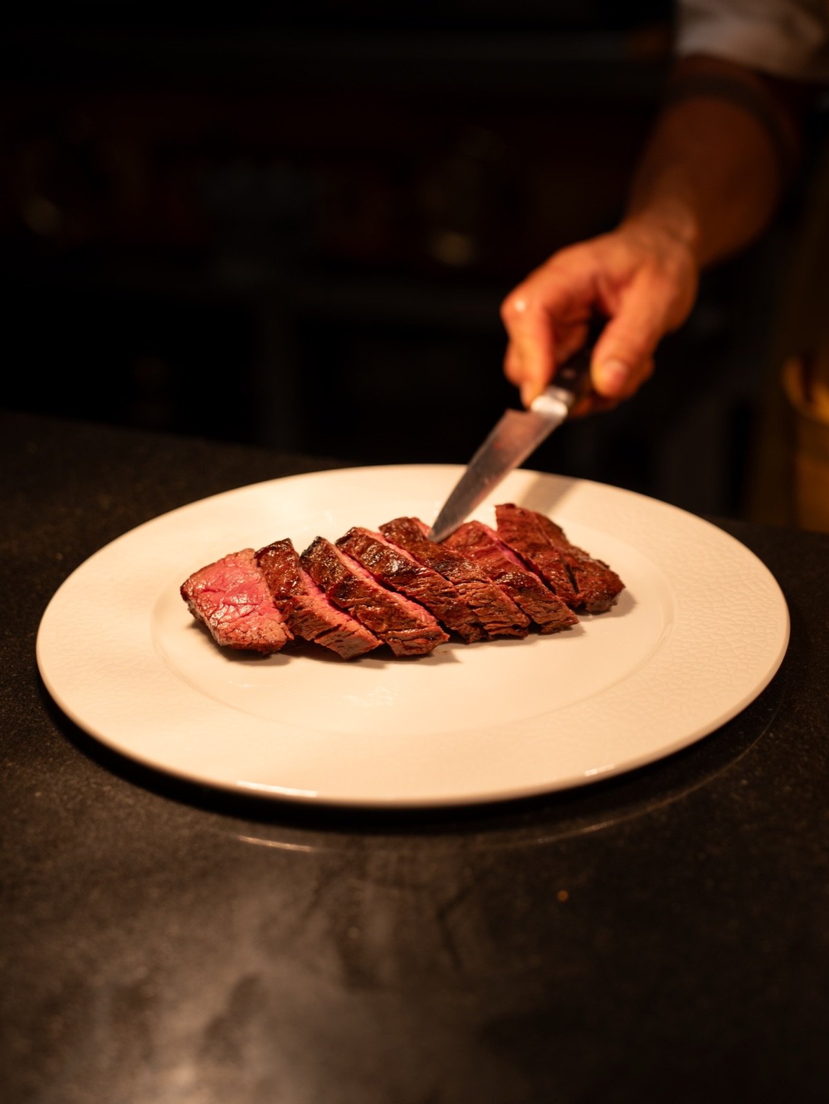 Sliced steak on a white plate