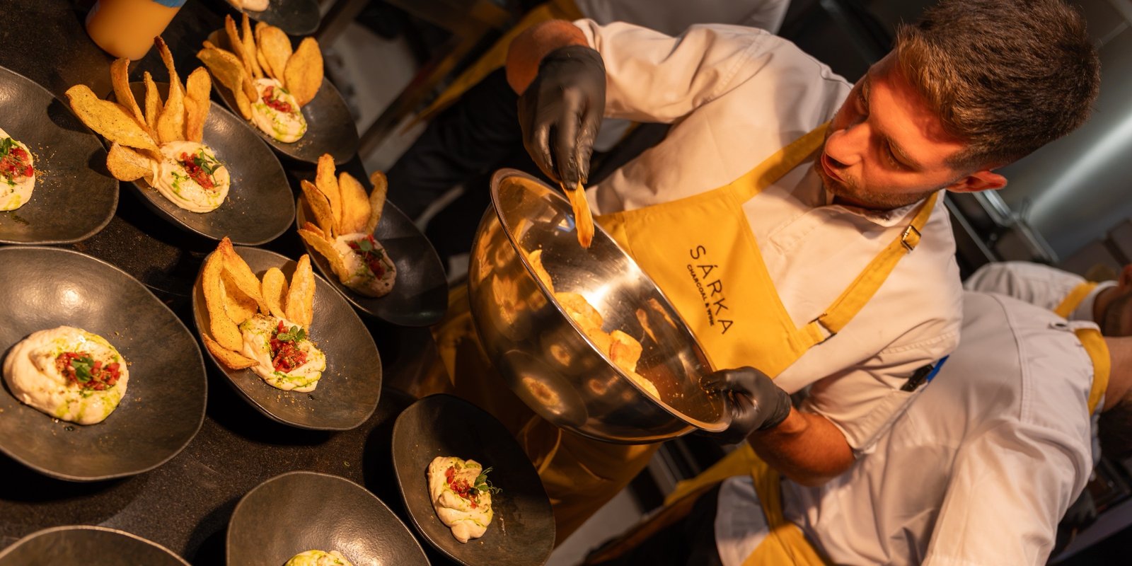 A SÁRKA chef plating dishes during service